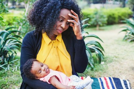 Sad African American Woman Holding Her Child, FreepikStock Photo